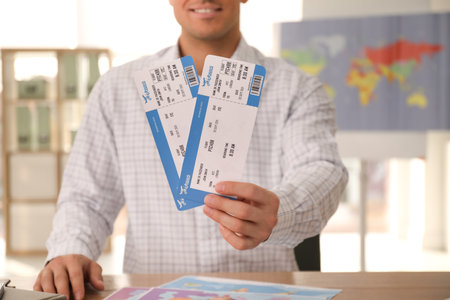 Travel agent with tickets at table in office, closeupの写真素材