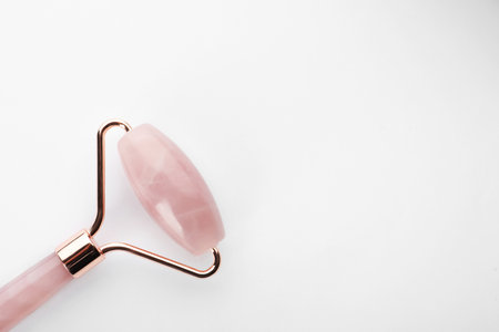 Rose quartz face roller on white background, top viewの写真素材