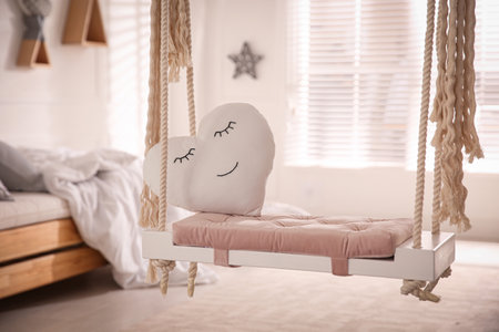 Beautiful swing with toy heart in the bedroom. Stylish interior designの写真素材