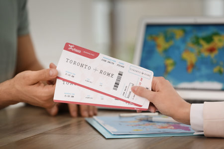 Travel agent giving tickets to client in office, closeupの写真素材