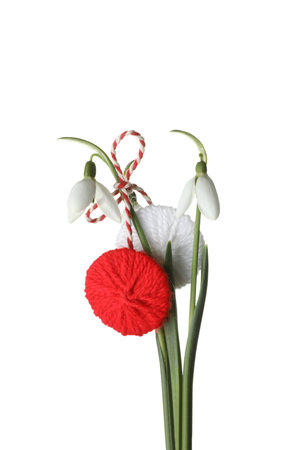 Beautiful snowdrops with traditional martisor on white background. Symbol of first spring dayの写真素材