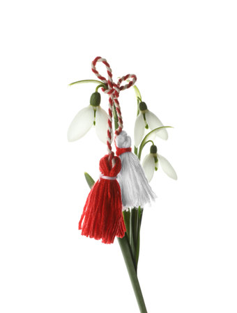 Beautiful snowdrops with traditional martisor on white background. Symbol of first spring dayの写真素材