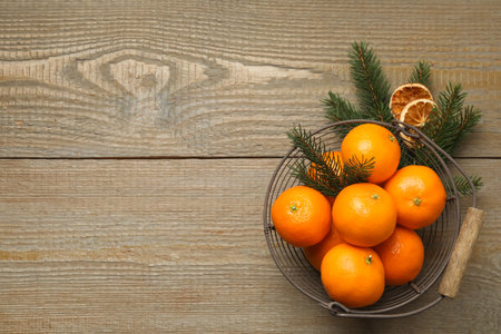 Flat lay Christmas composition with fresh tangerines on wooden table, space for textの写真素材