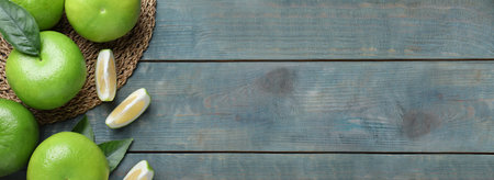 Fresh ripe sweetie fruits on blue wooden table, flat lay with space for text. banner designの写真素材