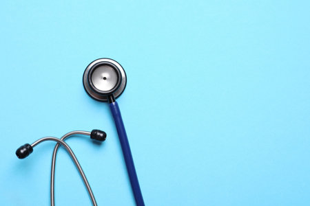 Stethoscope on light blue background, top view. Space for textの写真素材