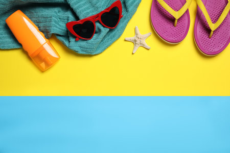 Flat lay composition with beach accessories on color background. Space for text