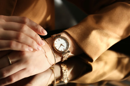 Woman wearing luxury wristwatch near mirror, closeupの写真素材