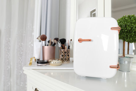 Mini fridge for cosmetic products on white vanity tableの写真素材