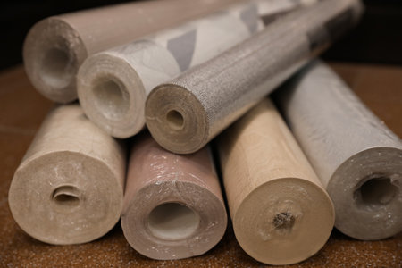 Different wall paper rolls on floor indoors, closeupの写真素材