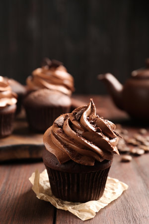 Delicious cupcake decorated with cream on wooden tableの写真素材