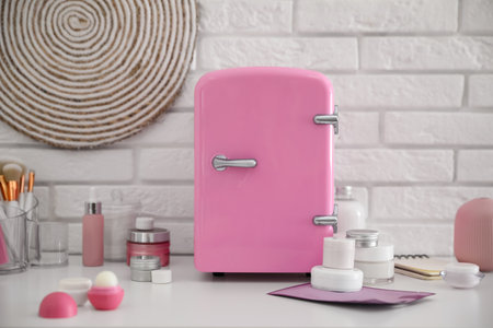 Mini fridge for cosmetic products on white vanity tableの写真素材