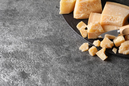 Parmesan cheese with board and knife on gray table. top view. Space for textの写真素材