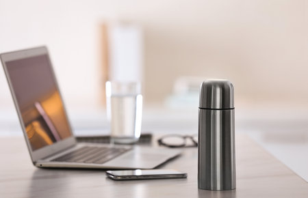 Thermo bottle on table in modern officeの写真素材