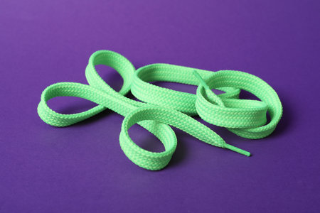 Mint shoe lace on purple background. Style accessoryの写真素材