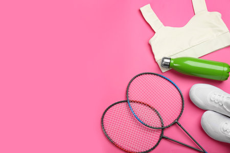 Rackets, sportswear and bottle on pink background, flat lay with space for text. playing badmintonの写真素材