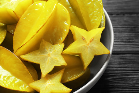 Delicious carambola fruits on black wooden table, closeupの写真素材