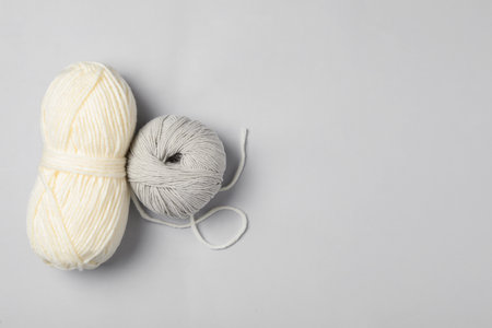 Soft woolen yarns on white background, flat lay. Space for textの写真素材
