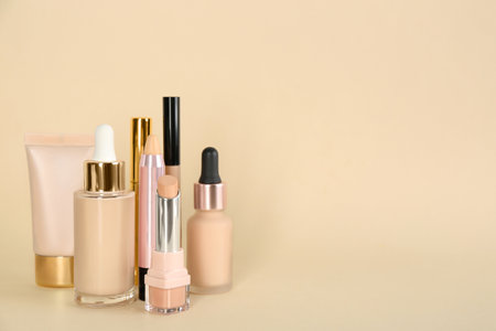 Foundation makeup products on beige background, space for text. decorative cosmeticsの写真素材