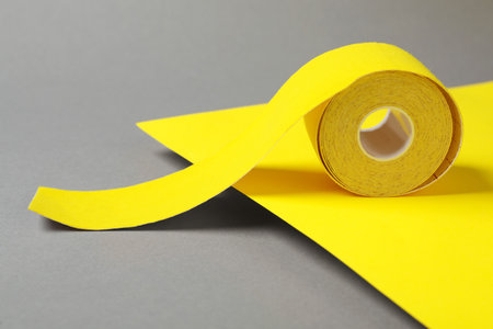 Bright kinesio tape in roll on color backgroundの写真素材