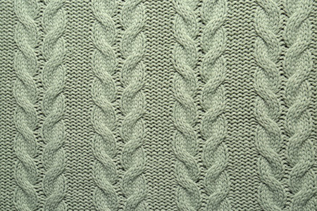 Gray knitted wool texture as background, top view