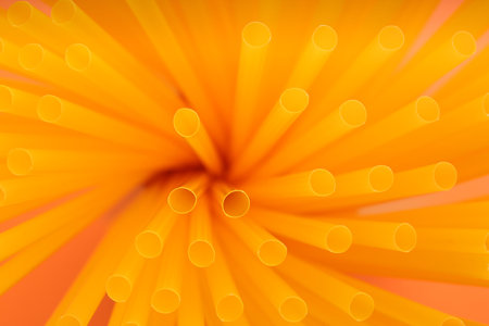 Heap of yellow plastic straws for drinks as background, closeupの写真素材