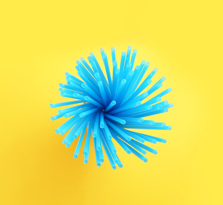 Blue plastic straws for drinks on yellow background, top viewの写真素材