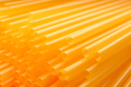 Heap of yellow plastic straws for drinks as background, closeupの写真素材