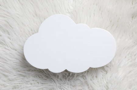 Cloud shaped child's night lamp on white faux fur, top viewの写真素材