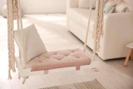 Beautiful swing with pillow in living room. Stylish interior designの写真素材