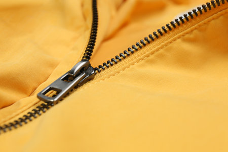 Yellow jacket with zipper as background, closeup viewの写真素材