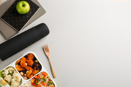 Flat lay composition with thermos and food on light gray background. Space for textの写真素材