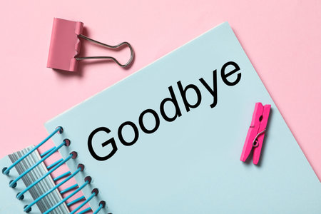 Notebook with text Goodbye on pink background, flat layの写真素材