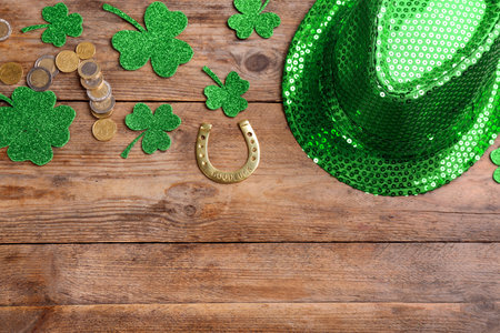 Leprechaun's hat and St. Patrick's day decor on wooden background, flat lay. Space for text