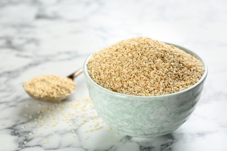 Sesame seeds in bowl on white marble tableの素材 [FY310201412066]