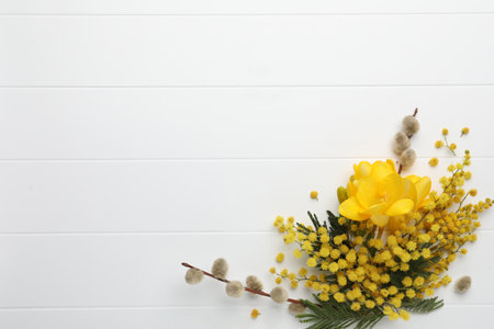 Beautiful floral composition with mimosa flowers on white wooden background, flat lay. Space for textの写真素材