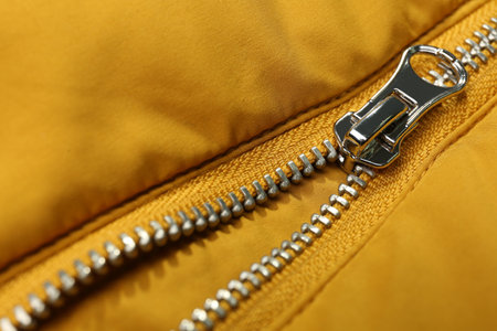 Yellow jacket with zipper as background, closeup viewの写真素材