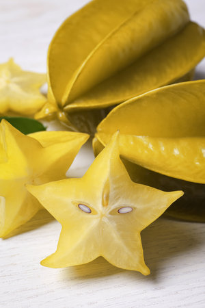Delicious carambola fruits on white wooden tableの写真素材