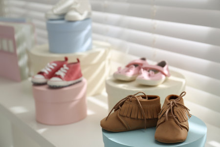 Small baby booties near window in store. shopping conceptの写真素材