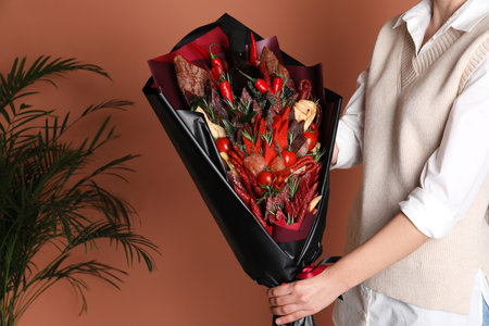 Woman with beautiful food bouquet on brown background, closeupの写真素材
