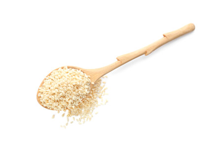 Wooden spoon with sesame seeds on white background, top viewの写真素材