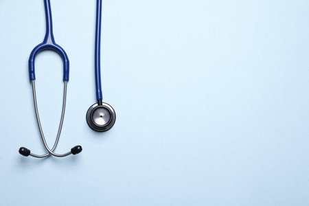 Stethoscope on light blue background, top view. Space for textの写真素材