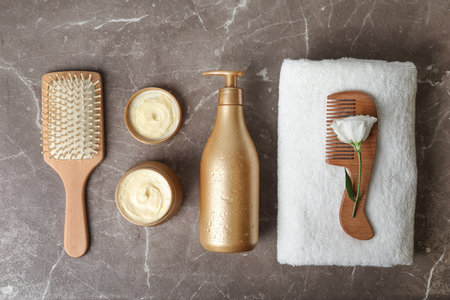 Flat lay composition with hair products and accessories on gray tableの写真素材