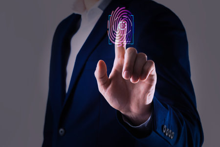 Man using biometric fingerprint scanner on gray background, closeupの写真素材