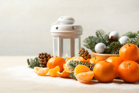Christmas composition with fresh tangerines and decorative lantern on white table, space for textの写真素材