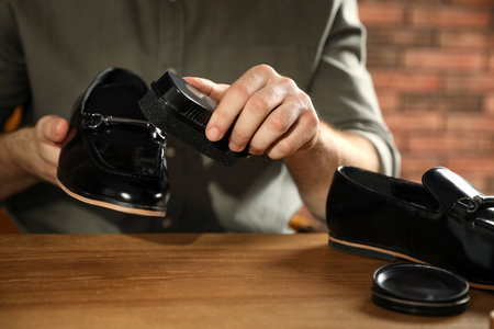 Master taking care of shoes in his workshop, closeupの写真素材