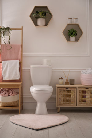 Stylish bathroom interior with toilet bowl and other essentialsの写真素材