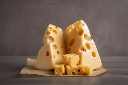 Pieces of delicious cheese on wooden tableの写真素材