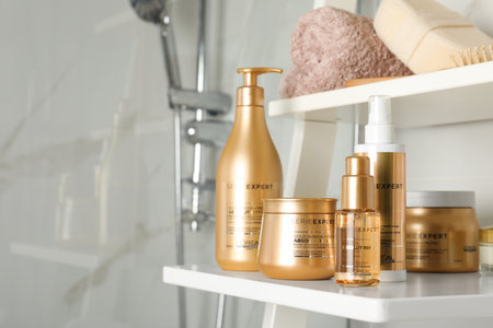 MYKOLAIV, UKRAINE - AUGUST 08, 2020: Set of L'Oreal hair care cosmetic products on white rack in bathroom. Space for textのeditorial素材