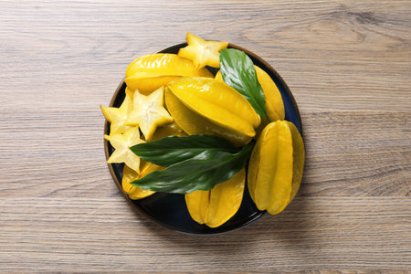 Delicious carambola fruits on wooden table, top viewの写真素材