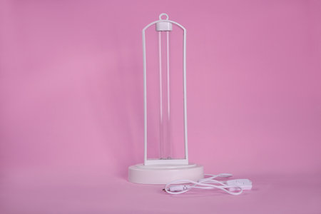 Ultraviolet lamp on pink background. air sterilizationの写真素材